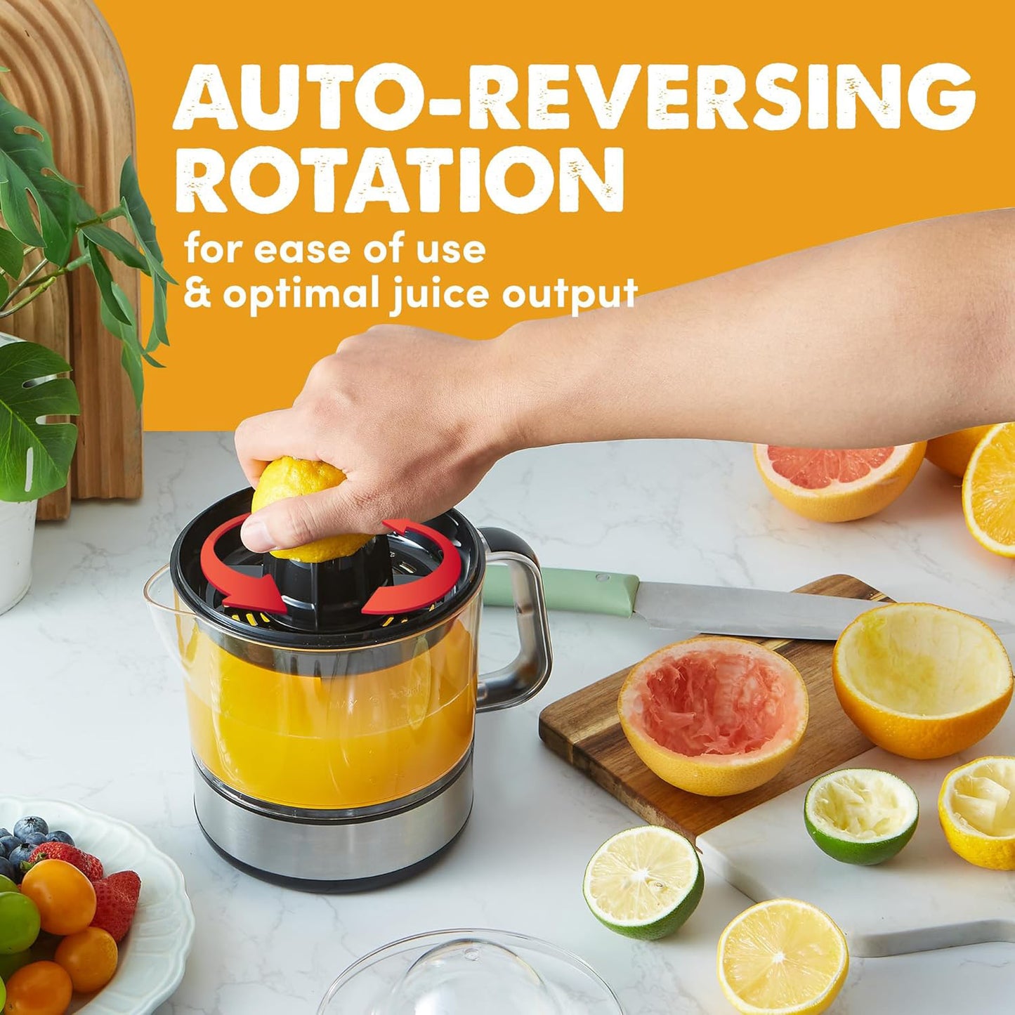 Person using a manual juicer with text 'Auto-Reversing Rotation' on an orange background.