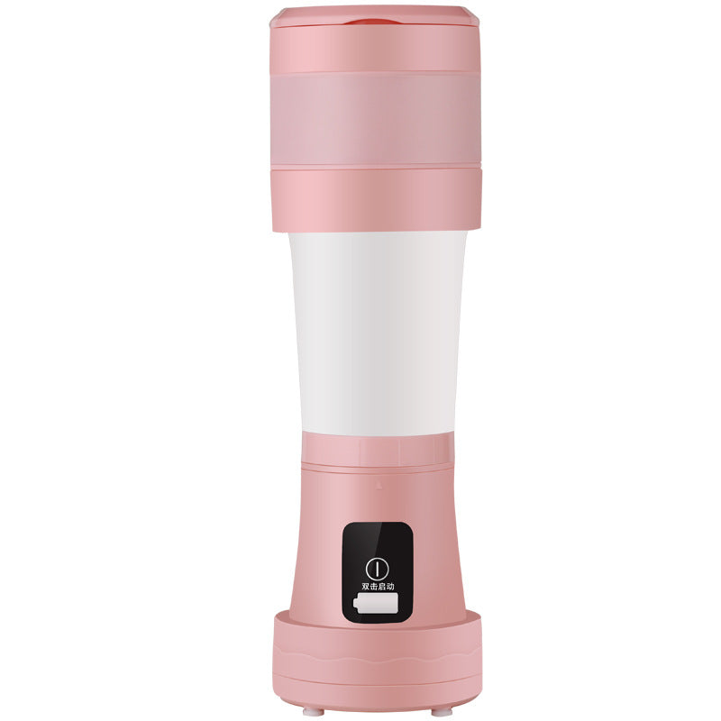 Pink and white portable juicer on a white background