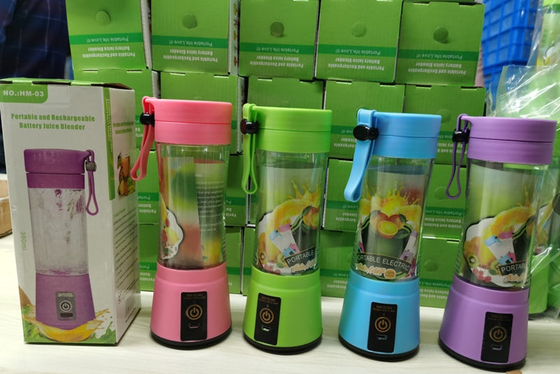 Four portable blenders in pink, green, blue, and purple with colorful drinks inside, surrounded by packaging.